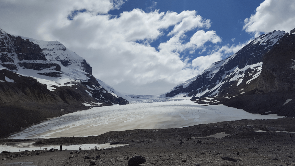 wide glacier spilling down a valley with no sediment in it