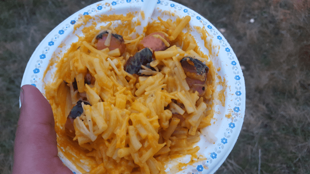 Mac and cheese with sausage in it in a paper bowl