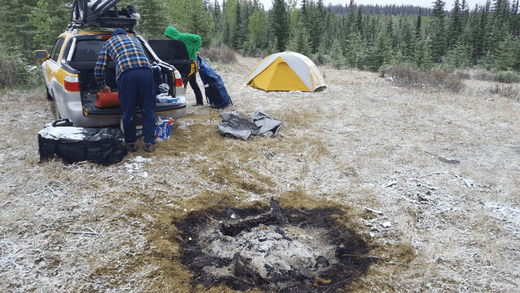 snowy campground with a extinguished fire