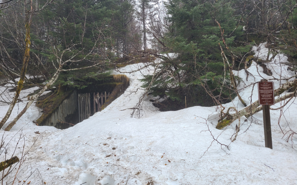 entrance covered in snow to underground fort