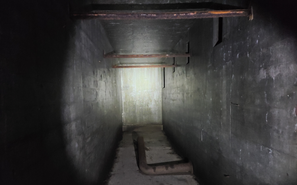 dark hallway with rusty piping