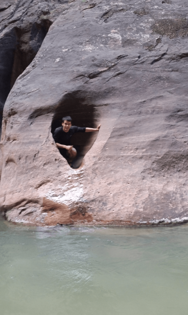 robert in a sandstone alcove above water