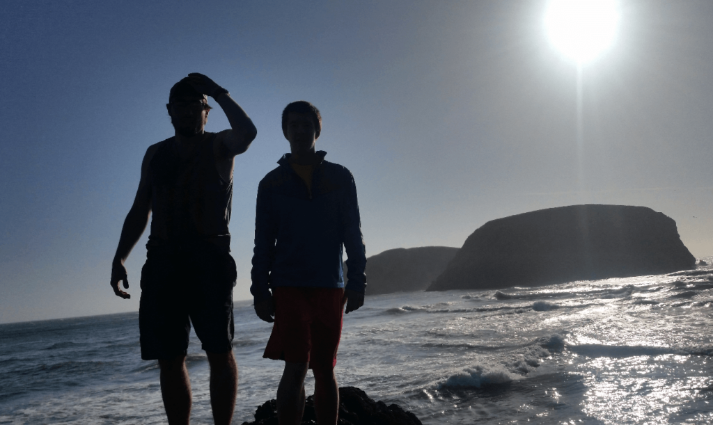 joseph and mike with seamounts and crashing waves behind