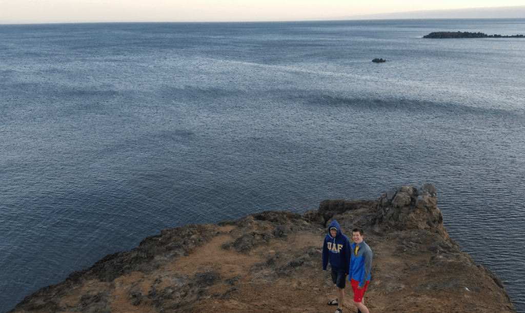joseph and michael in front of an uninterrupted ocean